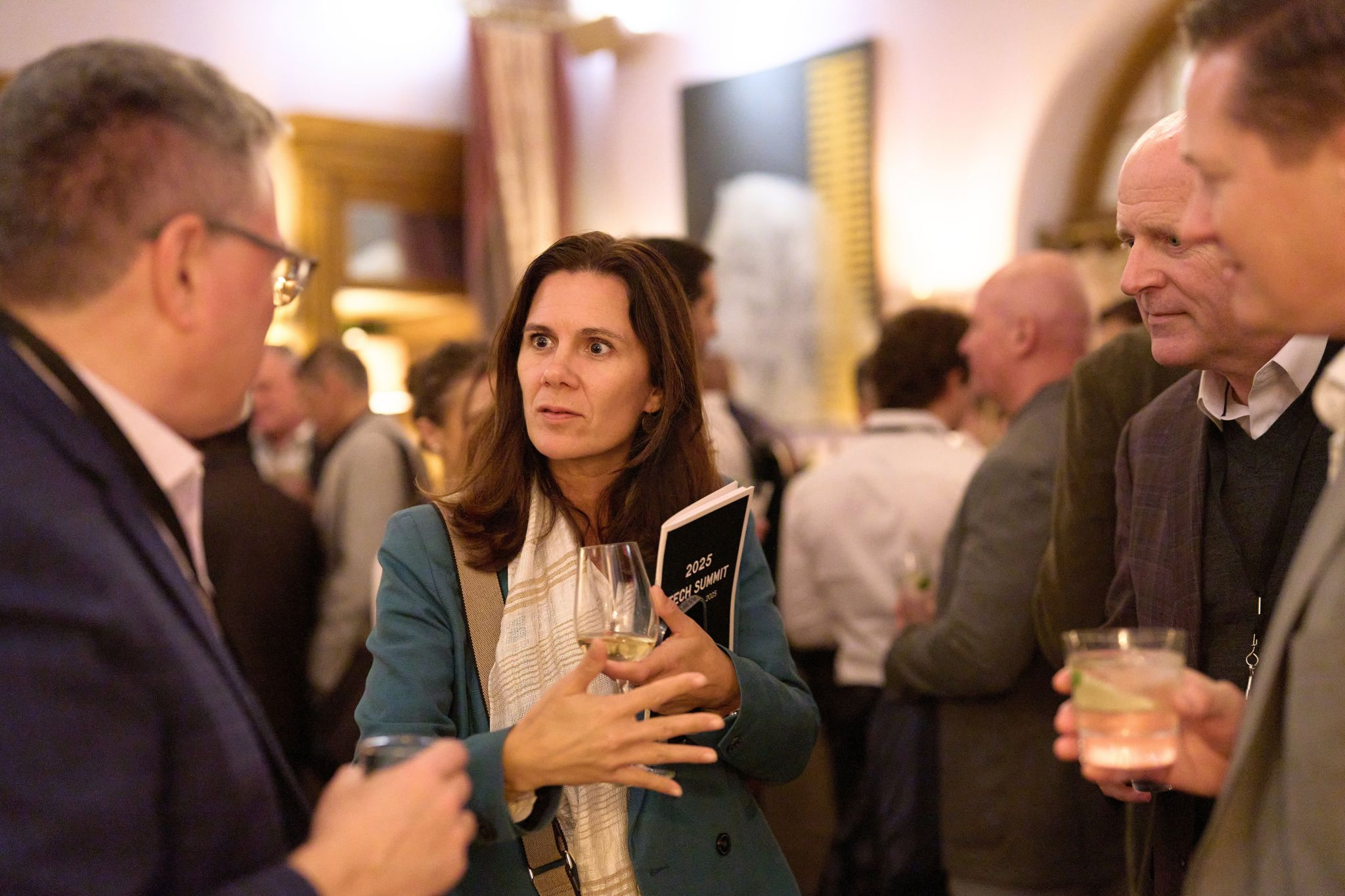 Attendees in conversation during a break